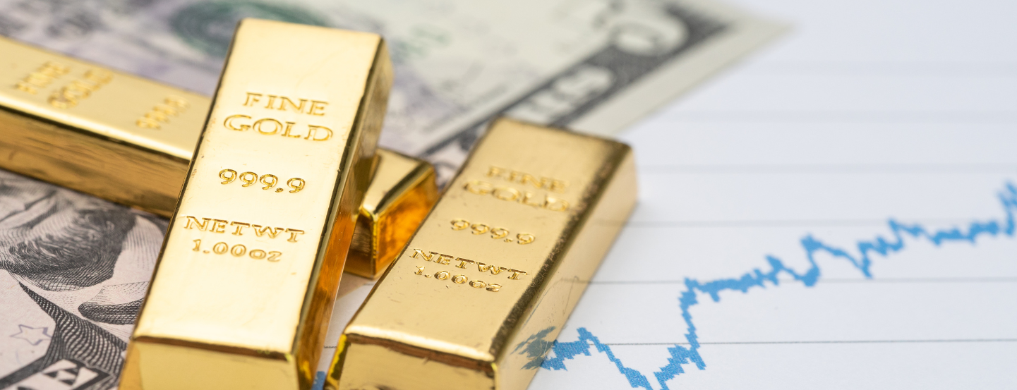 Gold bars on $5 bills and a chart.