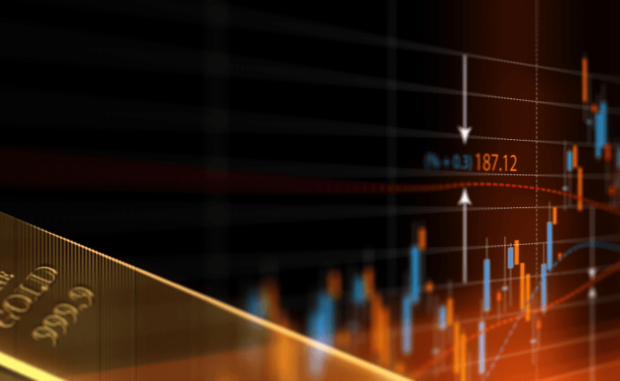 Image of a gold bar in front of a stock ticker in blue and red.